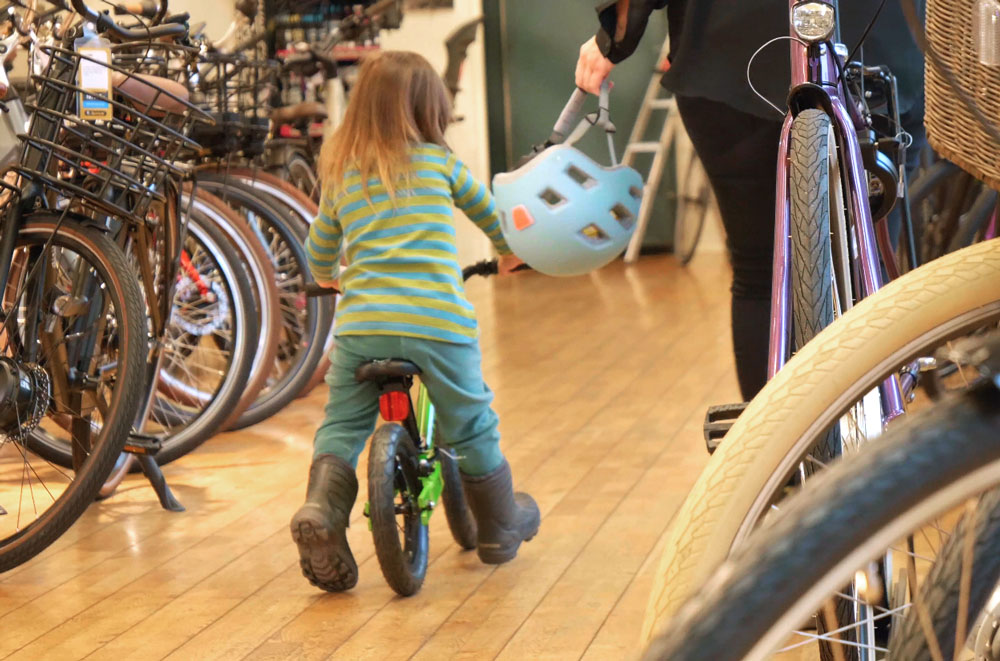 Ett barn testar en springcykel i en cykelbutik